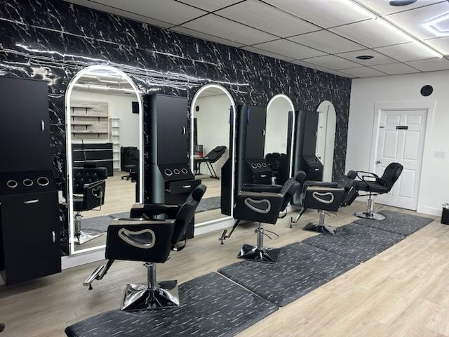 Styling chairs and arched mirrors inside Pavon Hair Salon