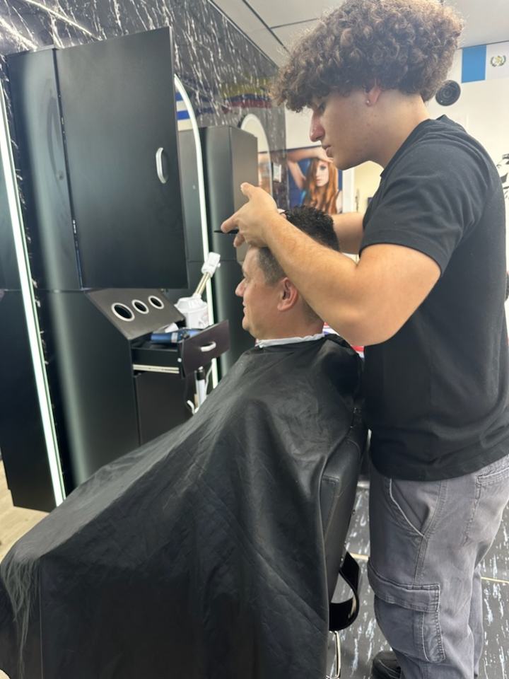 Barber giving a client a haircut