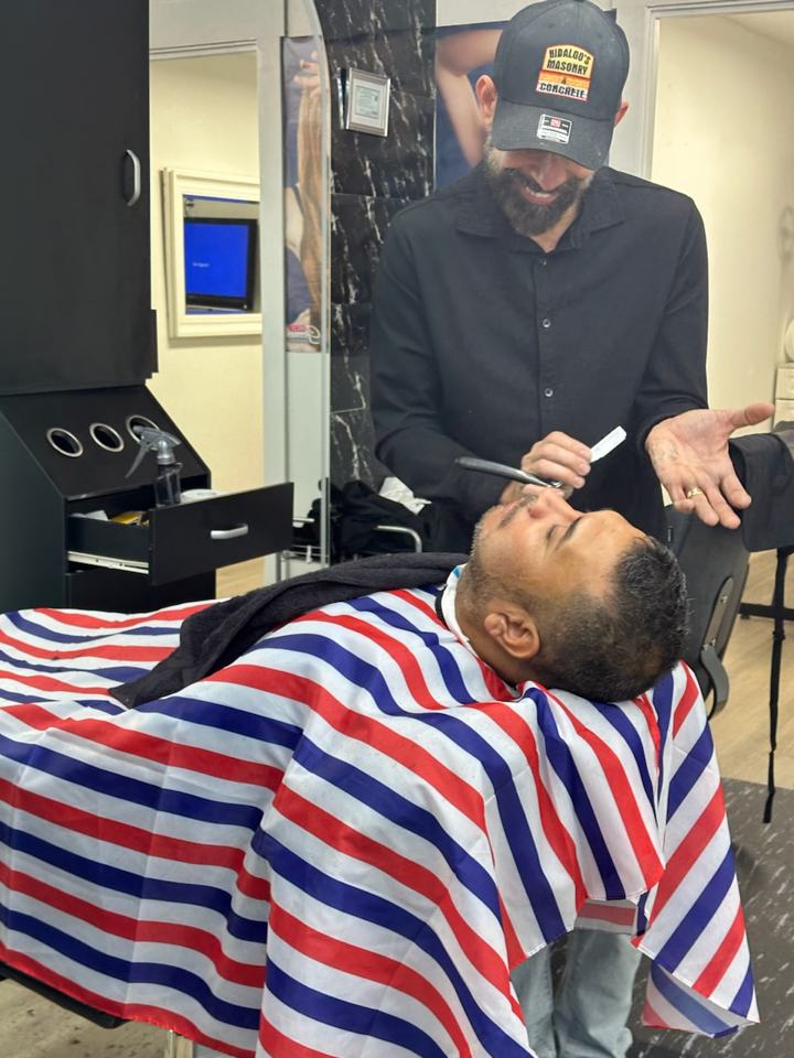 Client in the barber chair for a hot towel and beard service