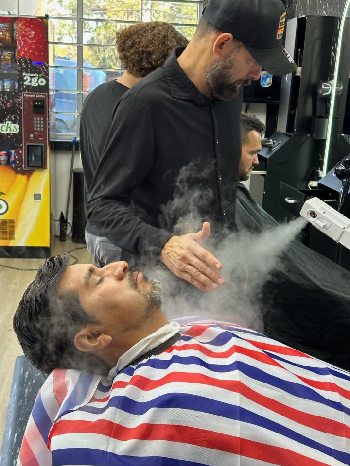 Barber styling a client's hair